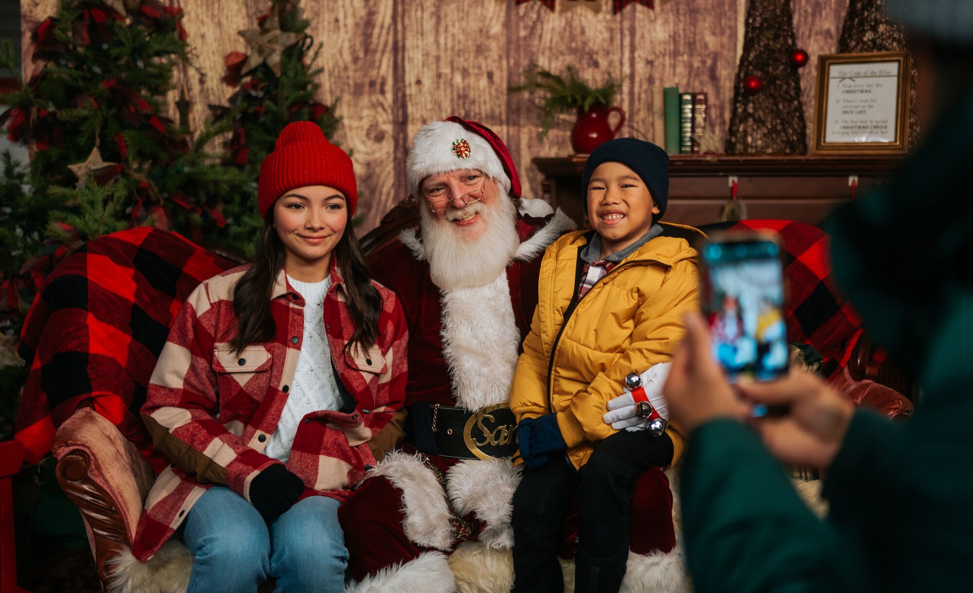 Two kids meet Santa Clause at the Banff Christmas Market during Christmas in Banff.